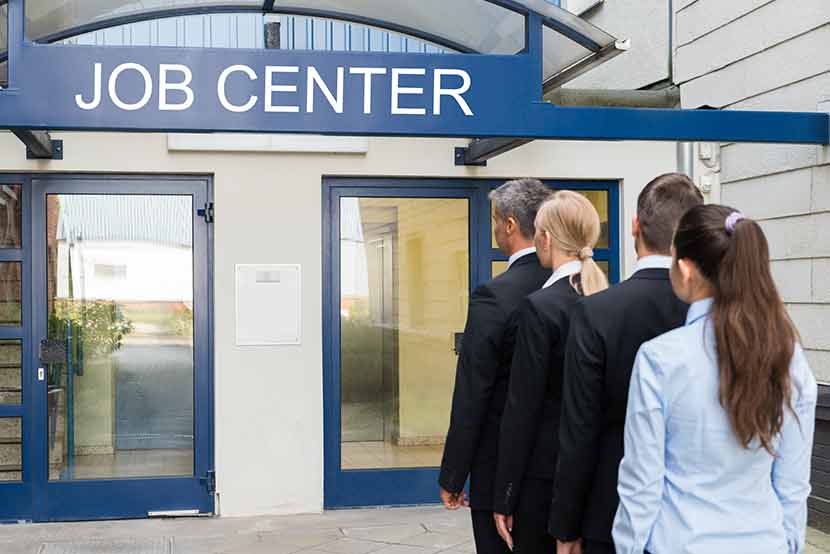 Variety of unemployed professionals lined up outside job center