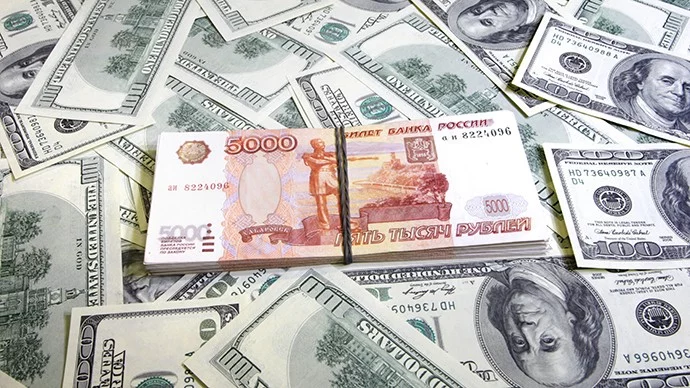 Stack of 5,000 denomination Russian ruble over stacks of dollars