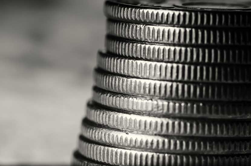 coin-stack-bw Magnified black and white view of the edge of a stack of platinum coins