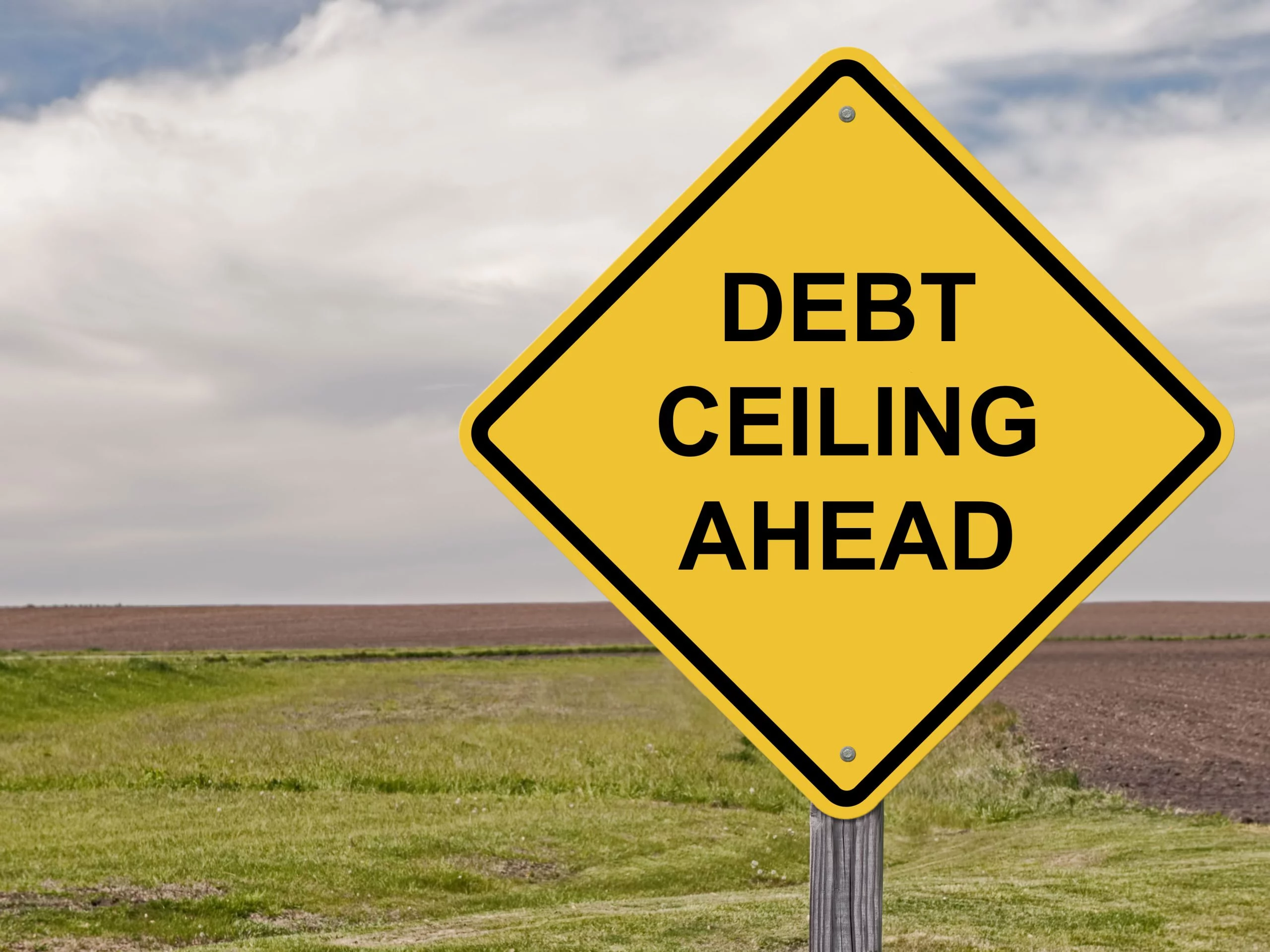 Yellow road sign warning that a debt ceiling is ahead