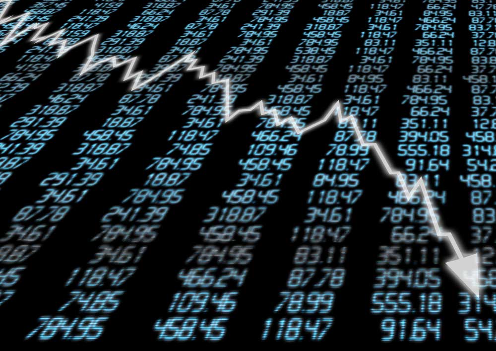 Jagged, falling arrow against backdrop of electronic stock prices
