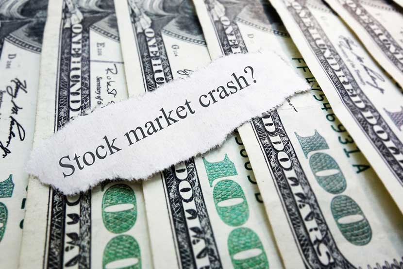 stock-market-crash One hundred dollar bills neatly lined up with a torn piece of paper reading "stock market crash?"
