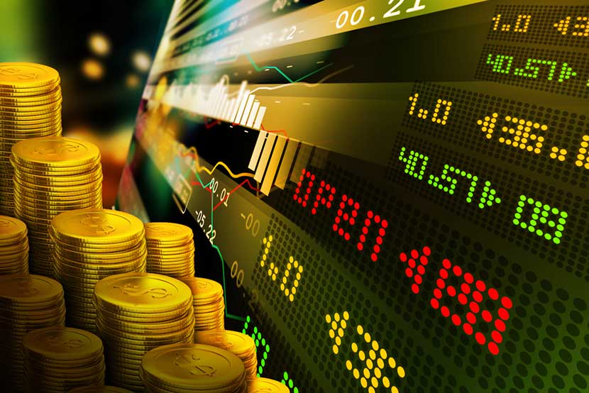 Gold coins juxtaposed with stock market readouts