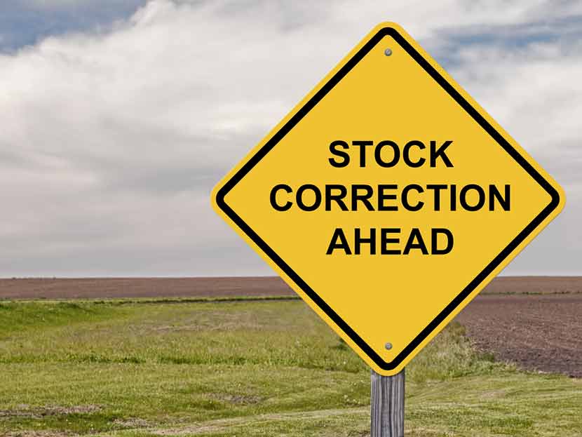 Yellow road sign against American farmland, reading "Stock Correction Ahead"