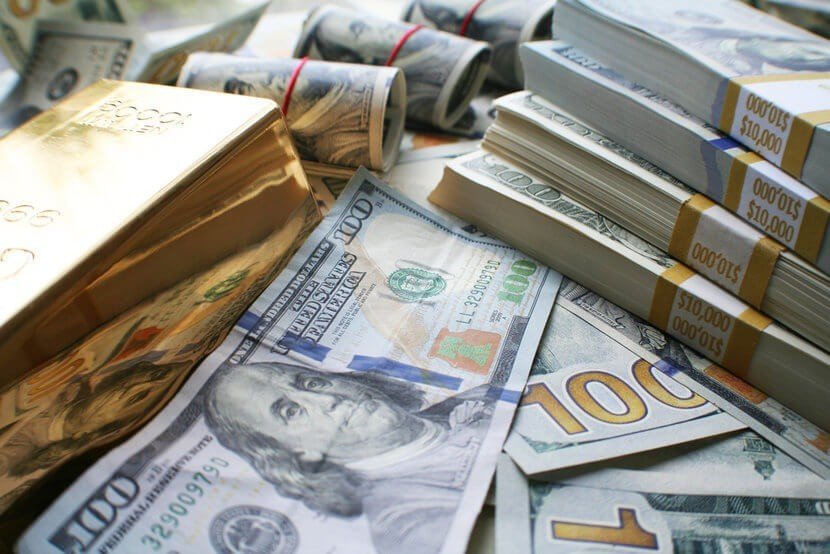 Gold bars and $100 bills, U.S. currency