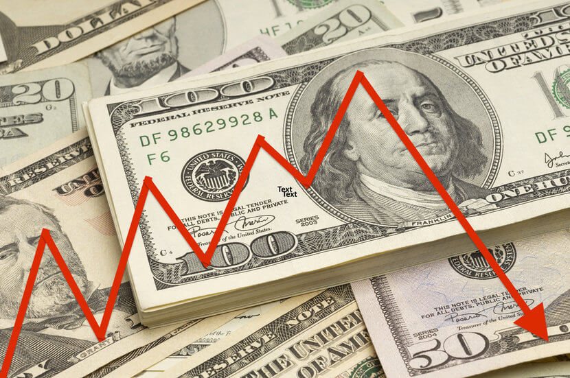 Various denominations of U.S. bills, with red arrow overlay indicating weak economy