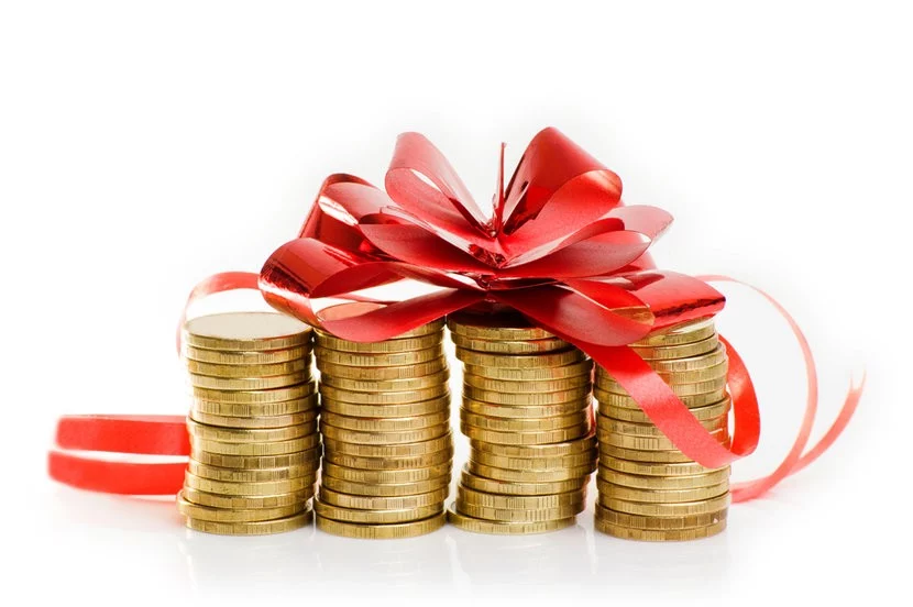 Four stacks of gold coins topped with large red ribbon