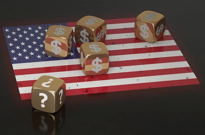 American flag against black background with gold dice sitting on top of it