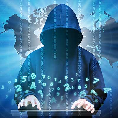 Man in black hoodie typing on keyboard with lines of code overlaid opaquely on him