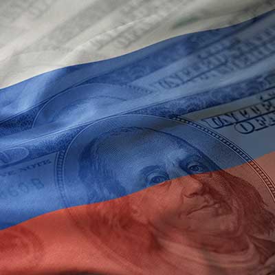 RussiaUSeconomy U.S. one hundred dollar bill faded into the Russian flag