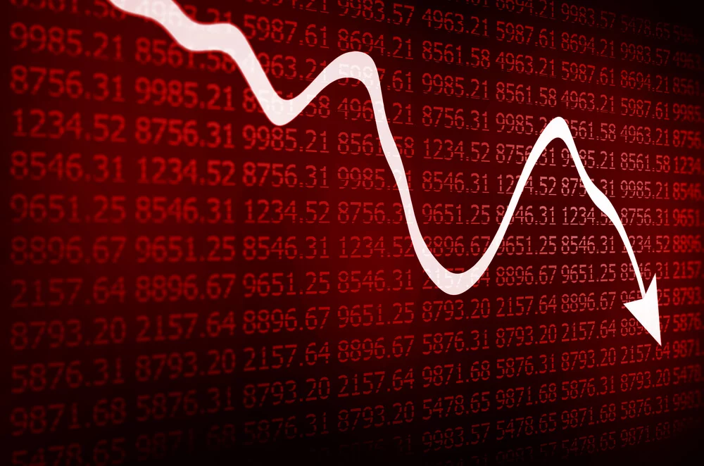 Stock market arrow graph going down on red display