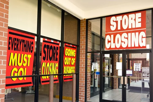 Everything must go store closing signs on business window