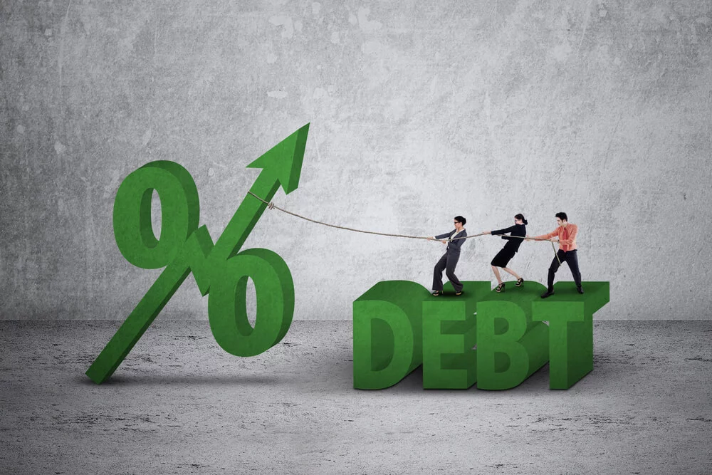 Businesswomen and man using a rope to pull percentage symbol with upward arrow and debt word down