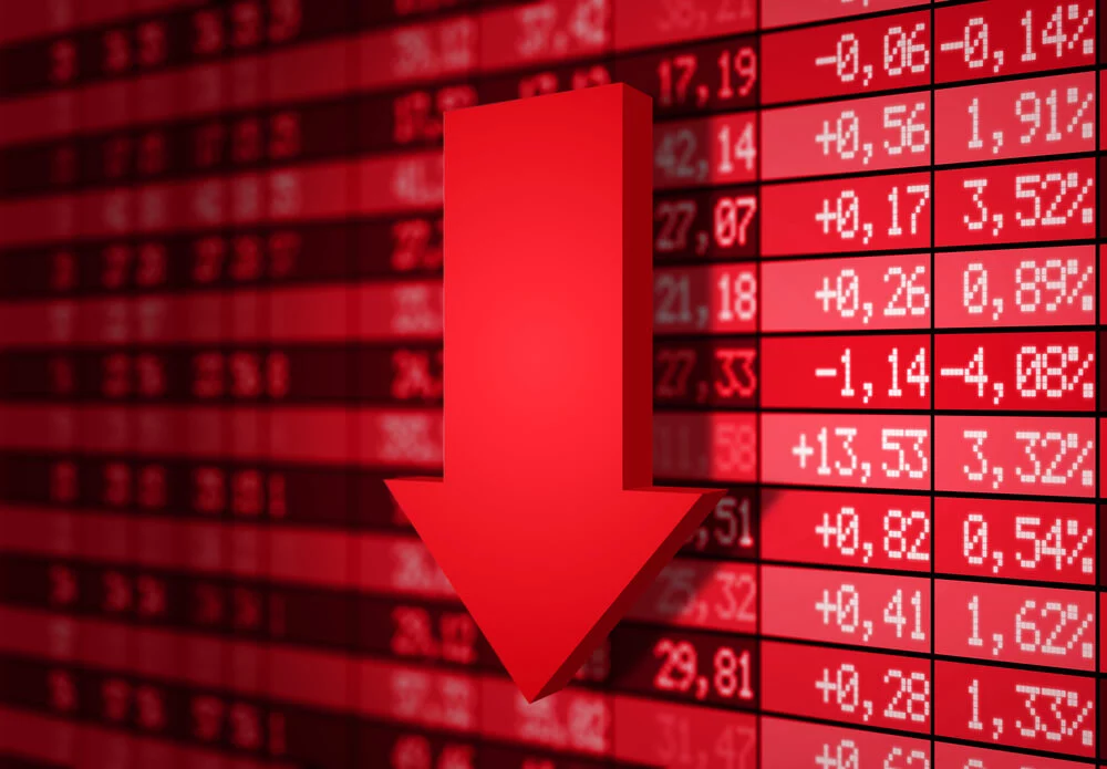 Volatile stock market charts with red arrow pointing down