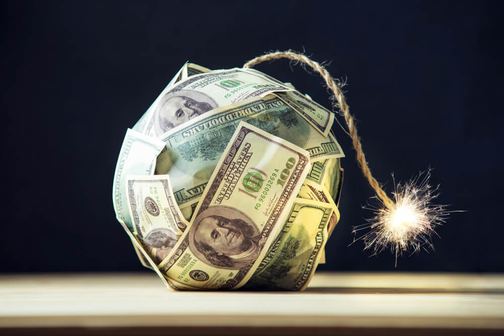 Big-bomb-of-money-hundred-dollar-bills-with-a-burning-wick.-Little-time-before-the-explosion.-The-concept-of-financial-crisis- Hundred dollar bills in the shape of a bomb with fuse lit