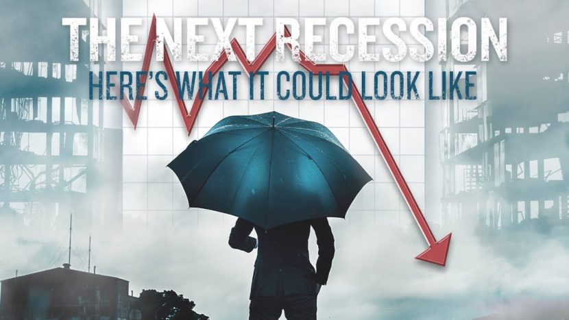 The Next Recession: Here’s What It Could Look Like businessman holding umbrella to protect himself from the next recession as shown by red downward arrow