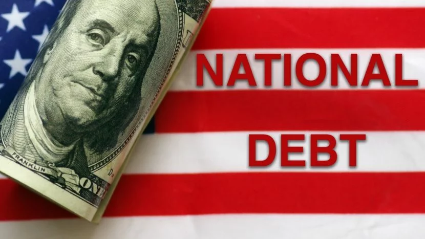 is the national debt a national disaster American flag behind a rolled up hundred dollar bill next to national debt wording