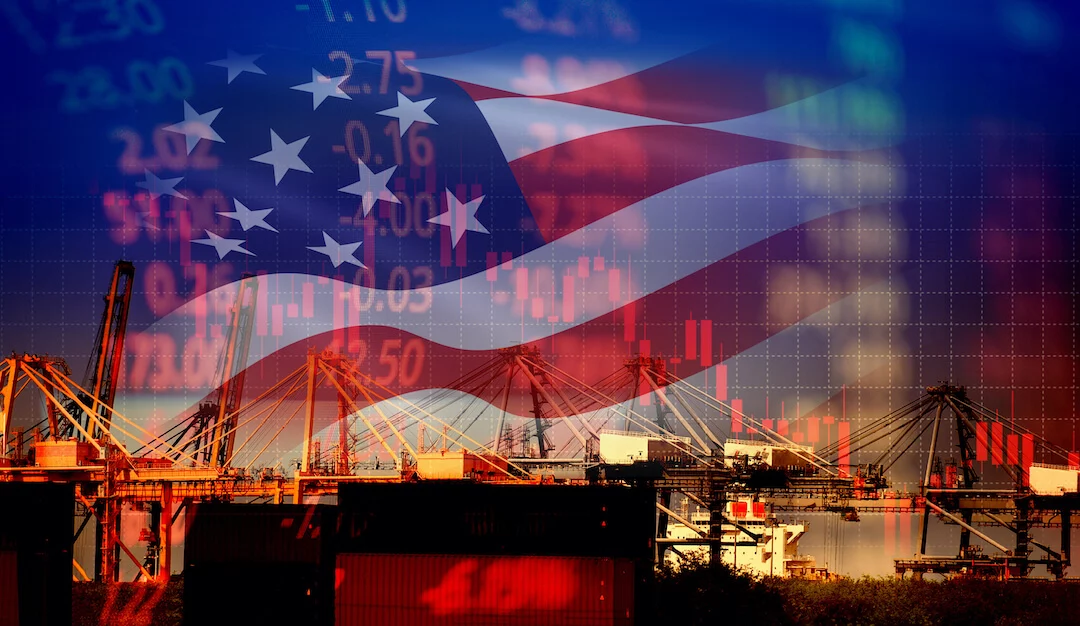 shutterstock_1400822942 US ports and manufacturing facilities in foreground over US. flag and stock graphs