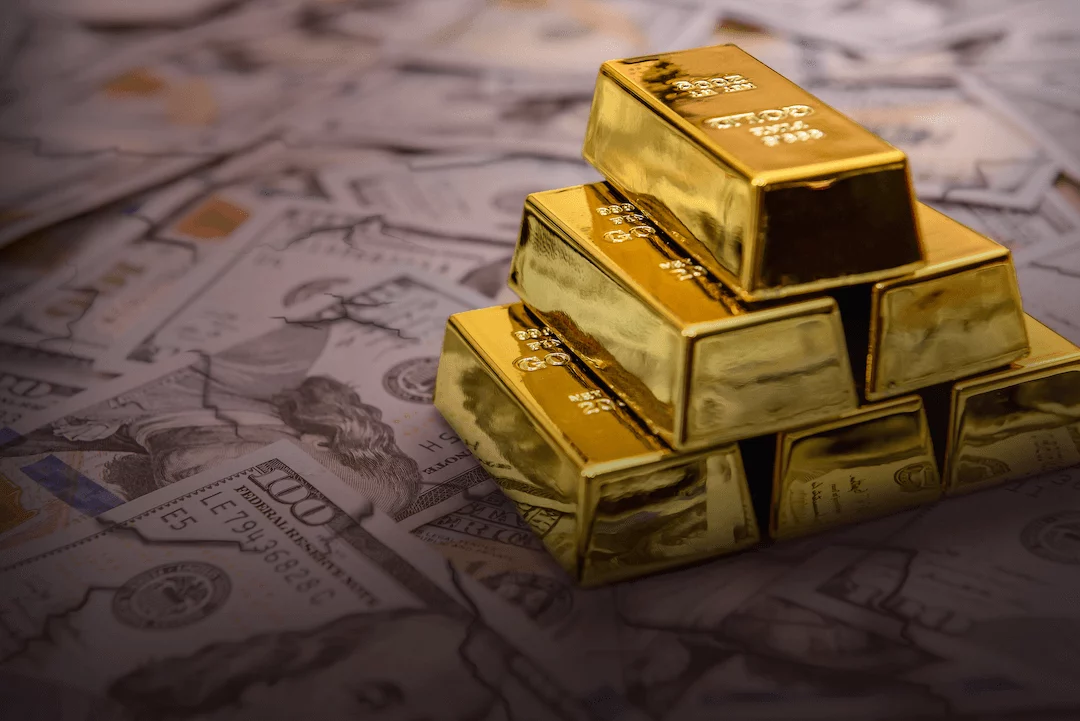 paper_wealth_blog_img Gold Bars Stacked on Top of One Hundred Dollar Bills
