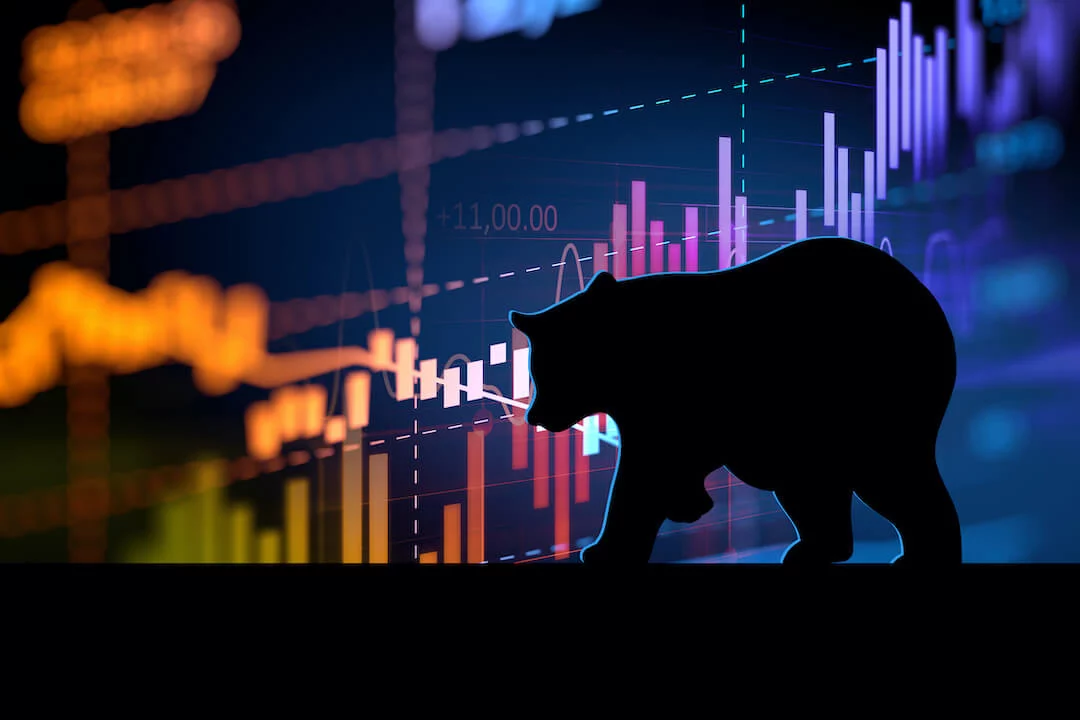 Shadow of bear walking in front of stock market graphic