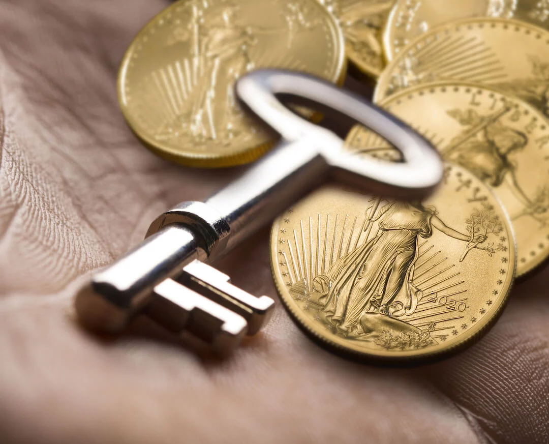Gold American Eagles with Key in Palm