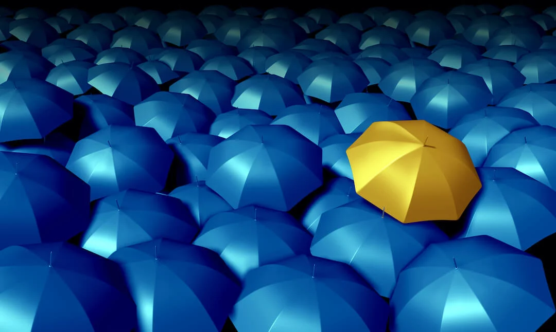 GNV_615_106723433 Gold Umbrella In the Midst of Blue Umbrellas