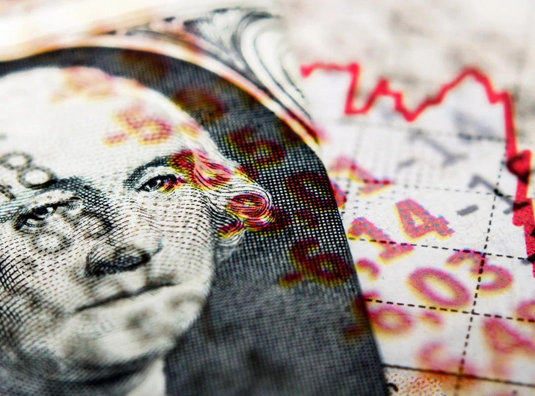 Dollar bill with chart overlay showing decline