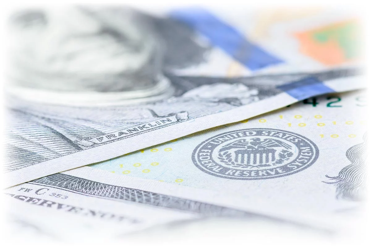 $100 bills with close-up on Federal Reserve stamp