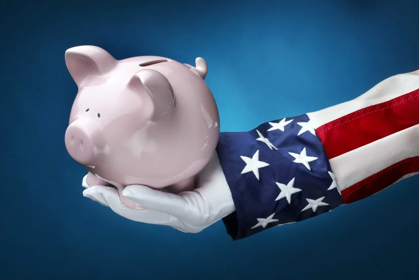 Patriotic sleeved arm holding piggy bank
