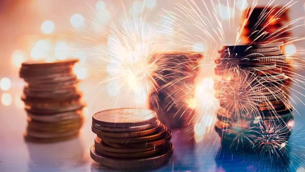Fireworks over stacks of coins