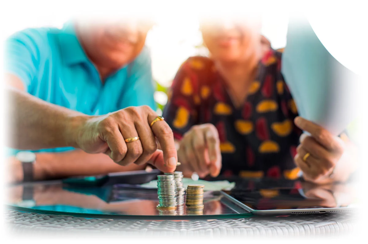 Mature couple examining stack of gold coins