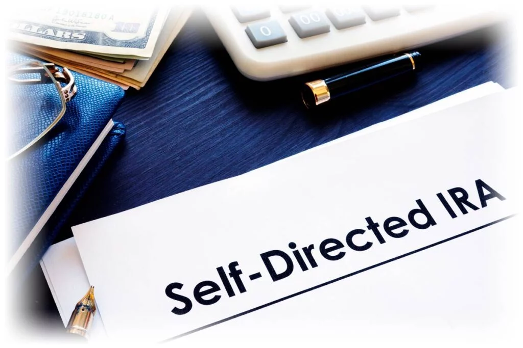 Self-Directed IRA document next to calculator and pen