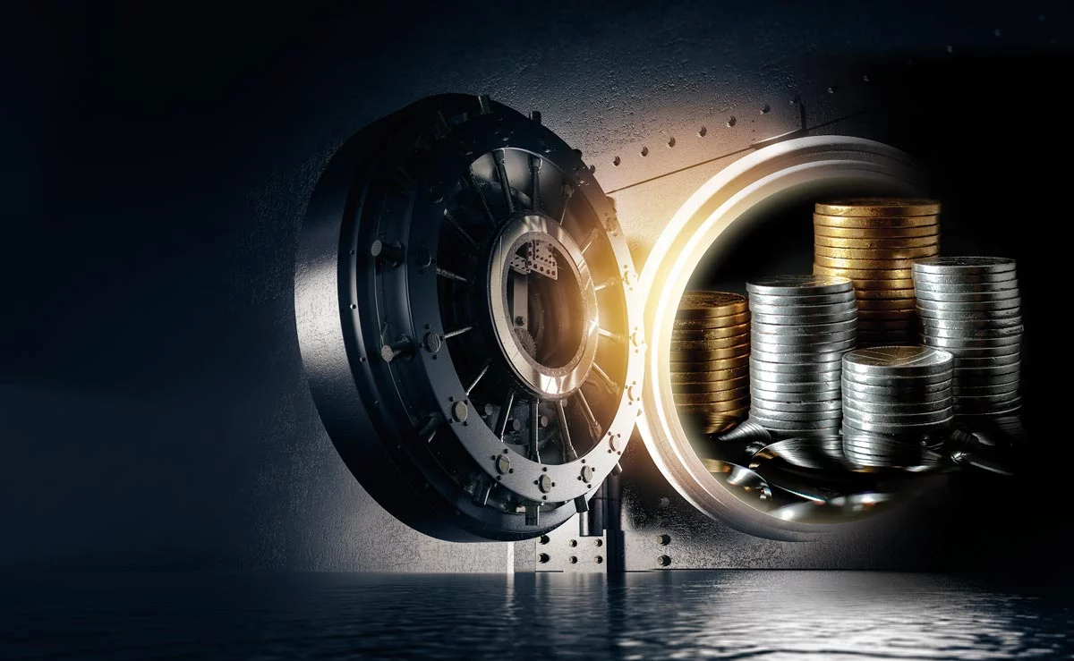 glowing_vault_coins_1200px Open bank vault filled with gold and silver coins