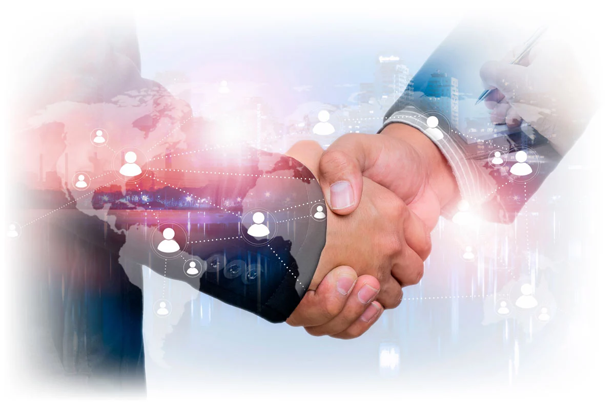 Business people shaking hands under image showing connections across a world map
