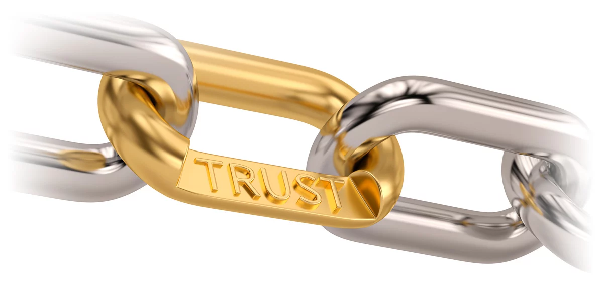 Metal chain with gold link labeled TRUST