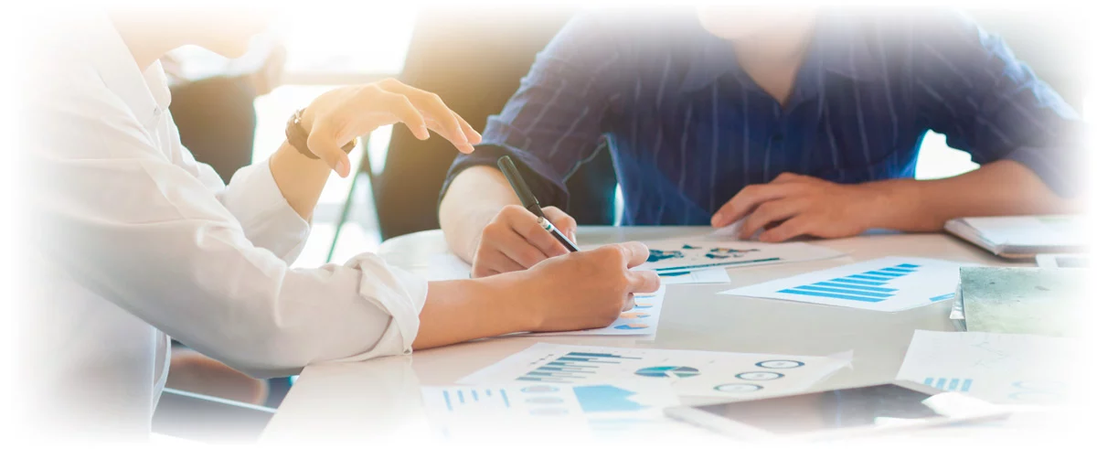 Two people working on financial portfolio plan