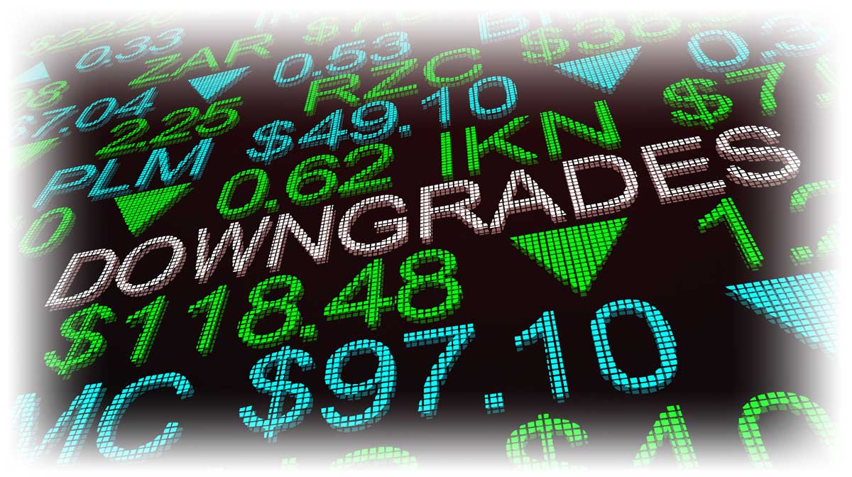 Word “DOWNGRADES” amidst stock ticker information