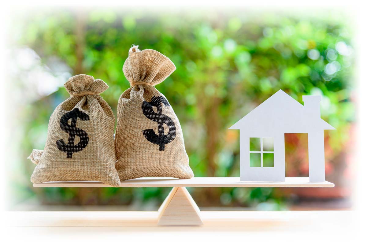 Seesaw with sacks of money balanced against a cutout of a house