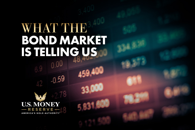 A board of prices with text "What the bond market is telling us" over it