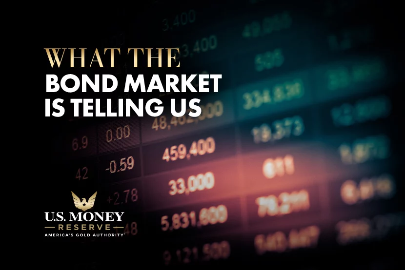 A board of prices with text "What the bond market is telling us" over it
