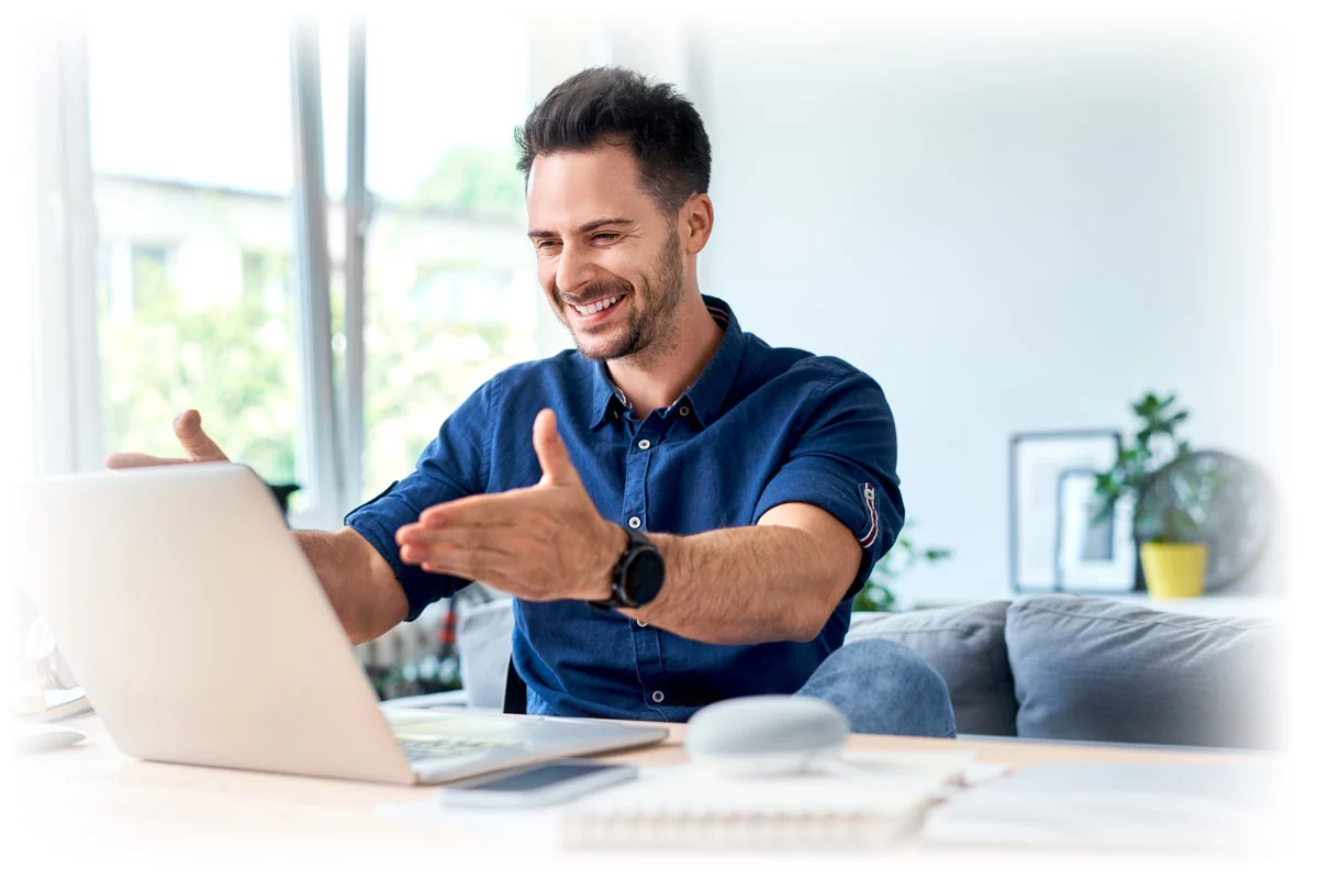Man motioning happily to laptop