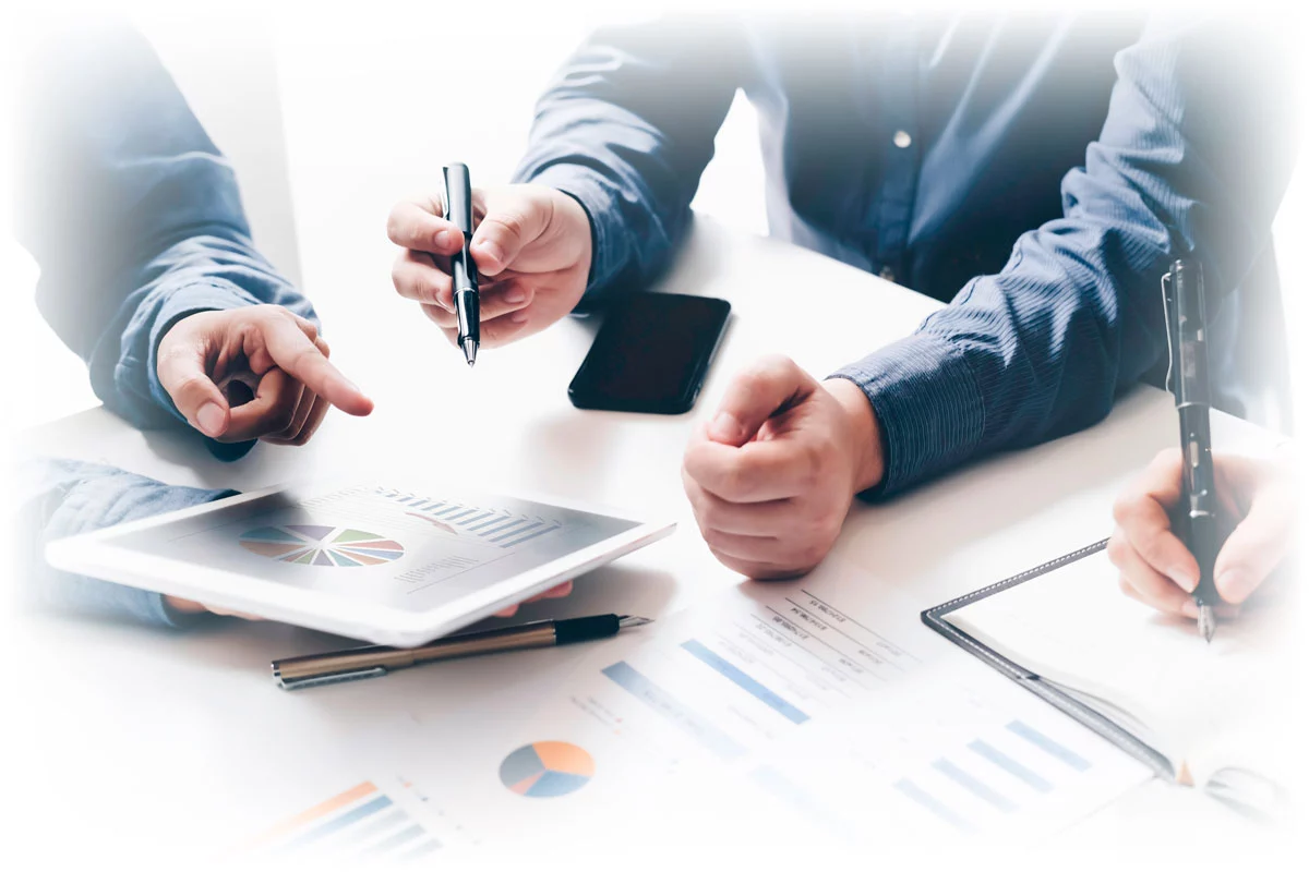 Hands over table and tablet with diversification charts and data