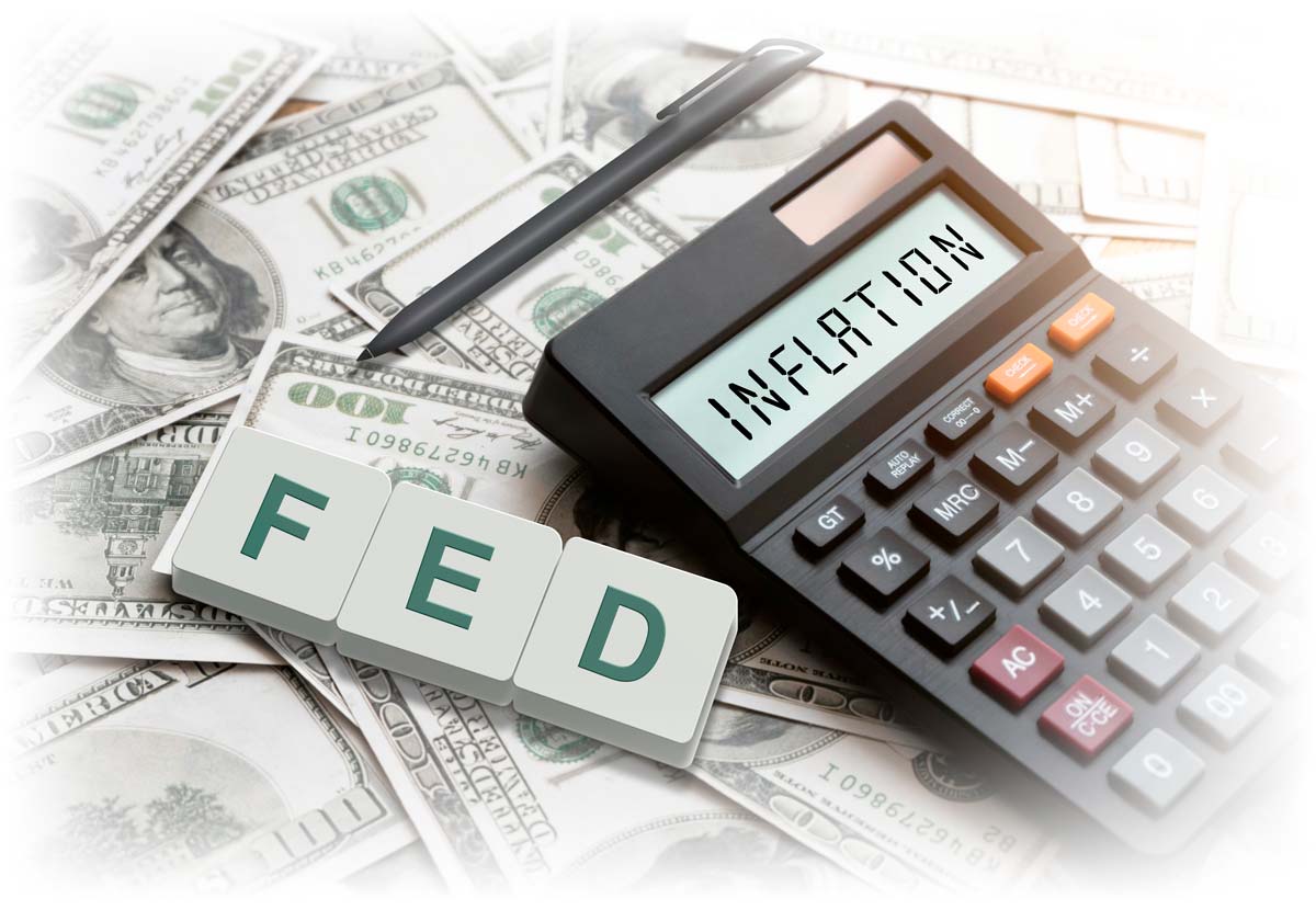 Inflation written on a calculator with dollar bills in the background