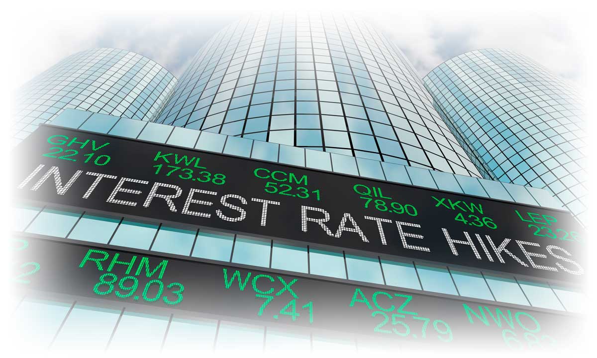 Glass building with stock ticker reading "INTEREST RATE HIKES"