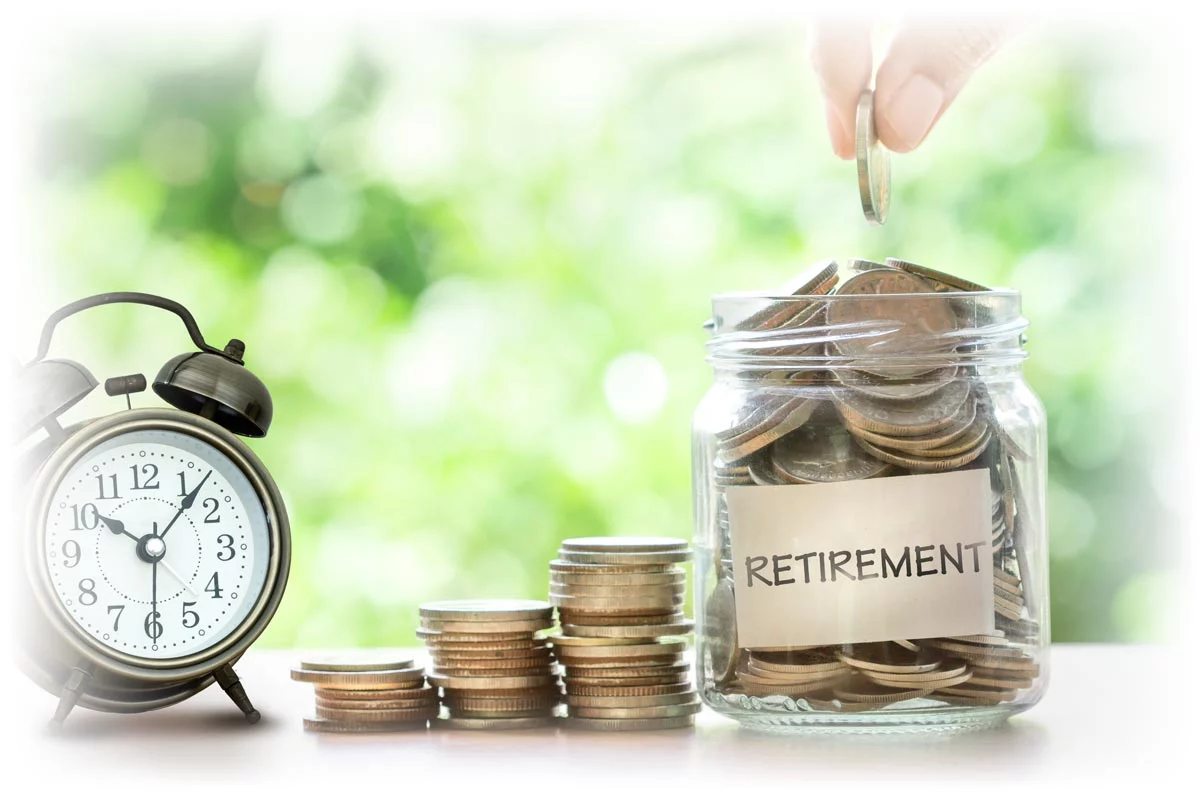 Alarm clock, stacks of coins, and jar of coins labeled “RETIREMENT”