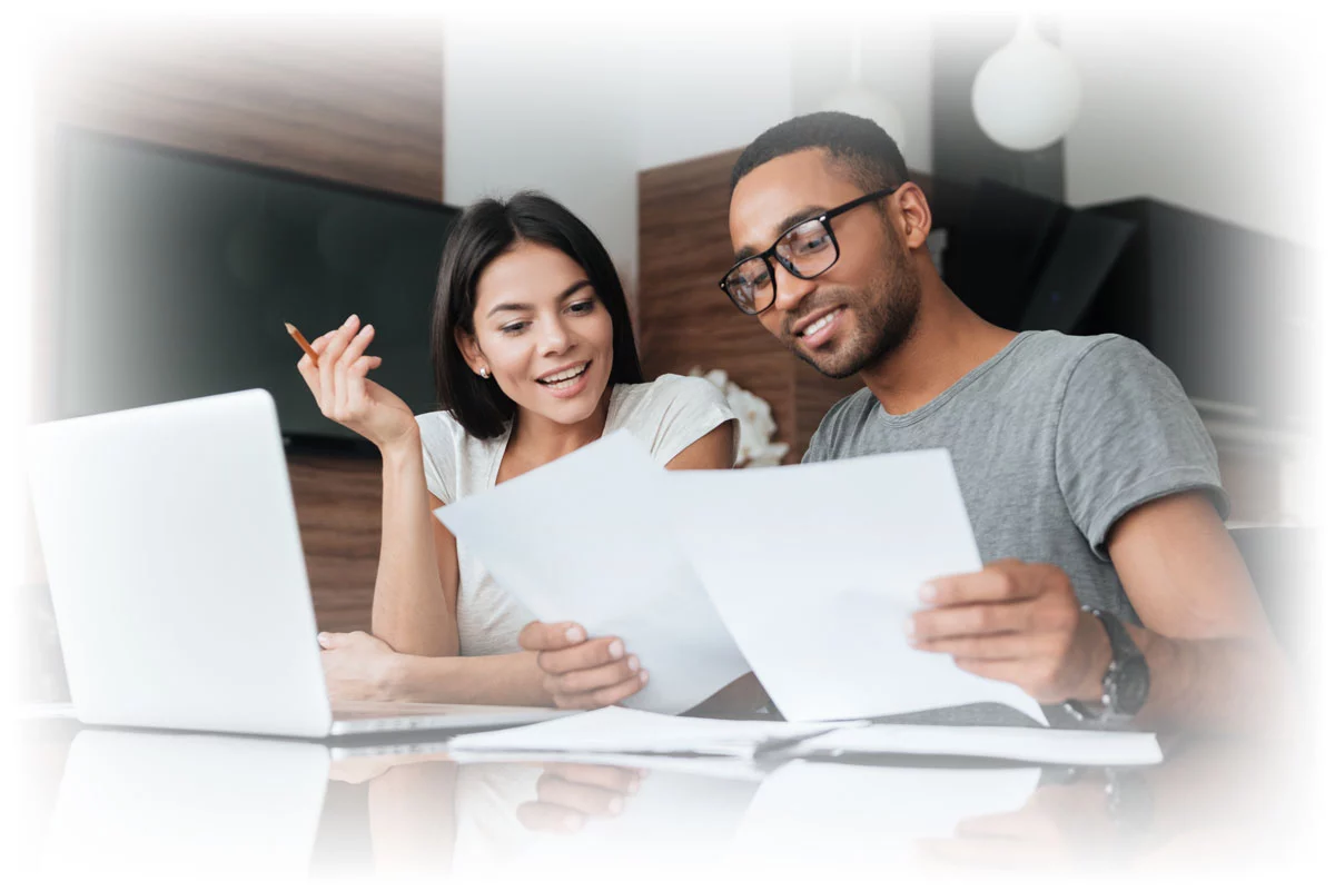 Couple working with paper and laptop