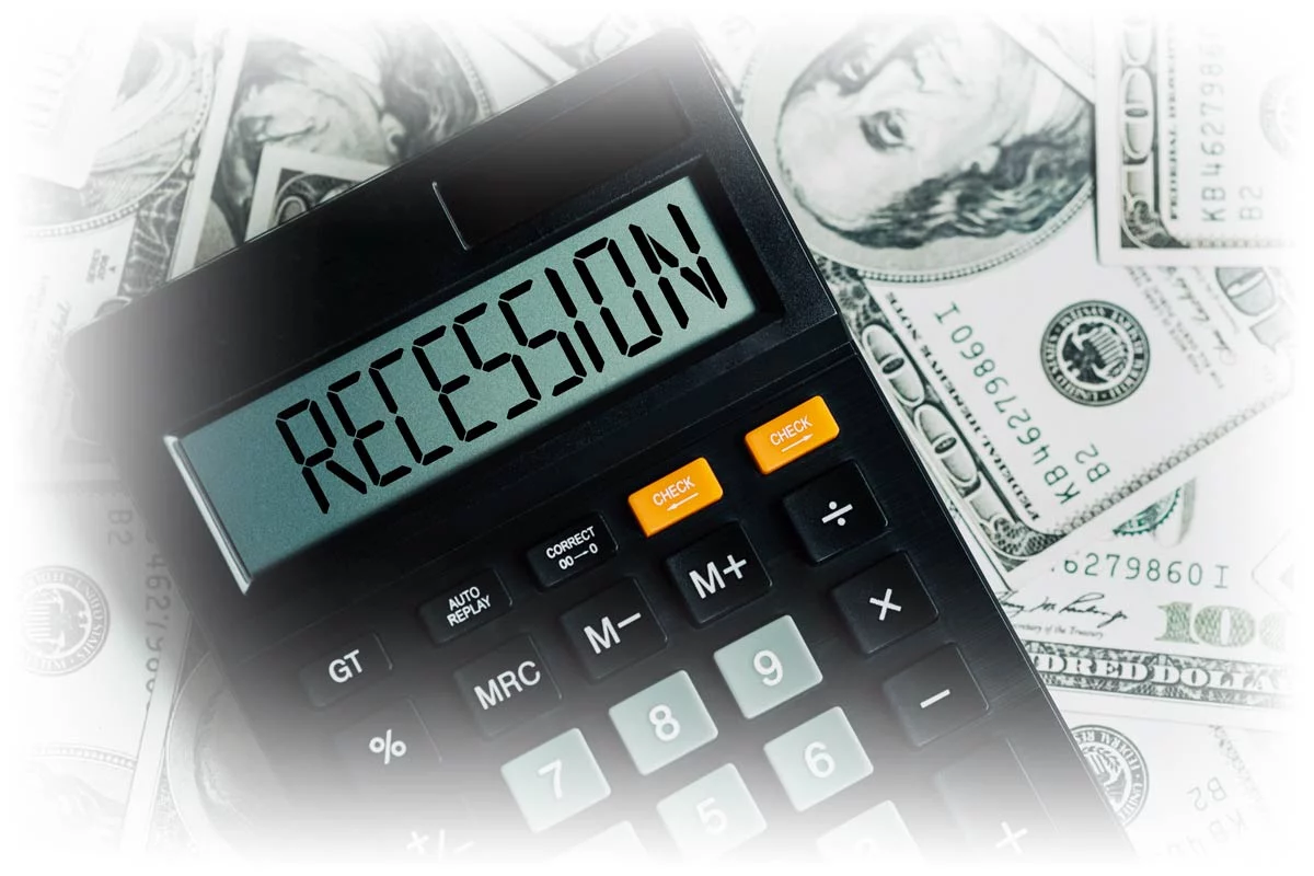 Calculator reading "RECESSION" over pile of $100 notes