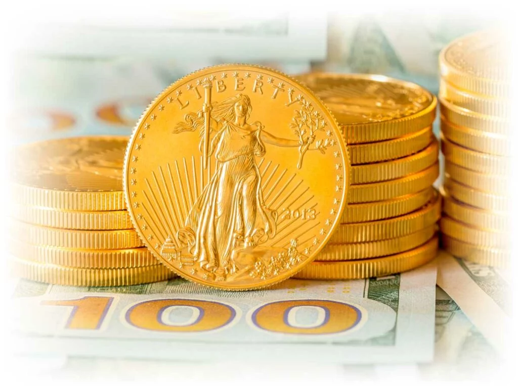 Stacks of Gold American Eagle coins over $100 notes