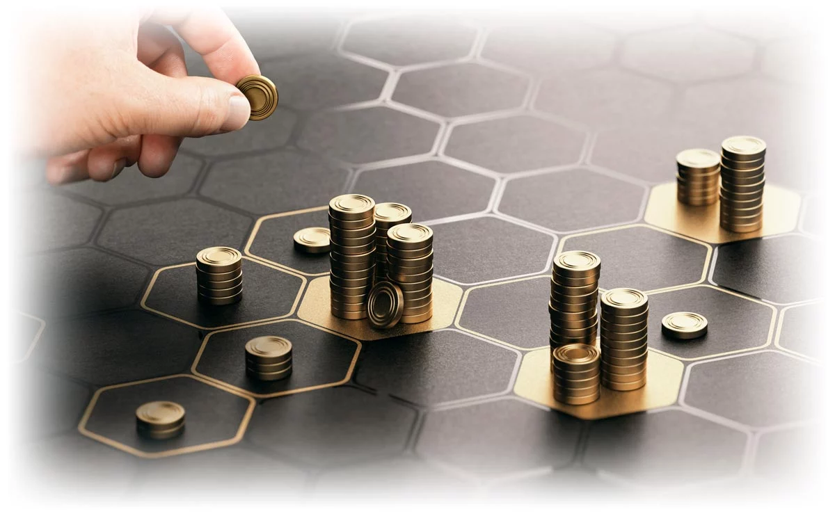 Hand separating coins into different piles on grid