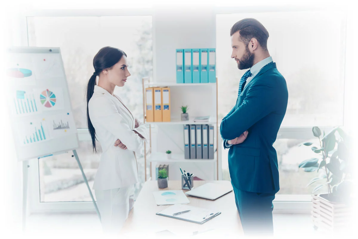 Business man and woman with arms crossed and data charts in background